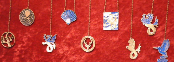 Several Atlantian award medallions hanging in front of a velvet backdrop